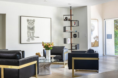 Large modern open concept living room in Los Angeles with white walls, light hardwood floors, a standard fireplace and a stone fireplace surround.