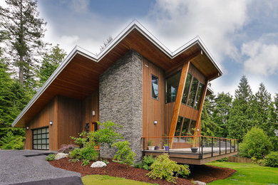 Large minimalist brown two-story mixed siding exterior home photo in Seattle