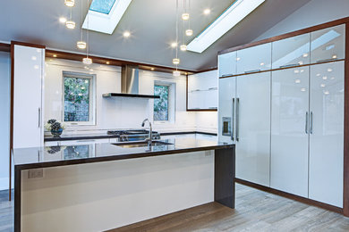 Design ideas for a mid-sized modern l-shaped open plan kitchen in Toronto with a single-bowl sink, flat-panel cabinets, white cabinets, quartz benchtops and with island.