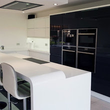 A Metz Gloss White And Gloss Graphite Kitchen With Corian Worktops