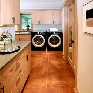Contemporary utility room in Milwaukee with concrete flooring and orange floors.
