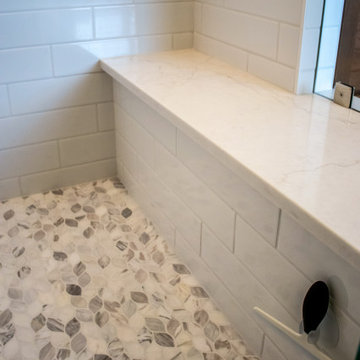 Luxury Spa Bathroom with Natural Warm Vanities, Quartz Countertop, Tiled Shower