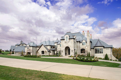 Huge elegant beige two-story stone gable roof photo