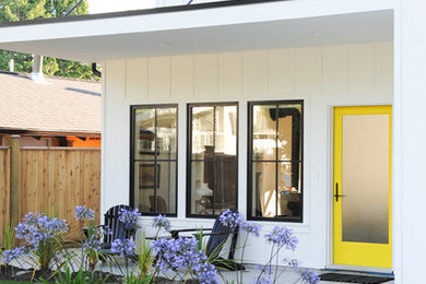 Example of a cottage white two-story concrete fiberboard house exterior design in Vancouver with a shingle roof