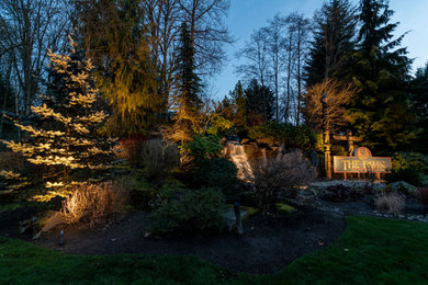 Photo of a mid-sized rustic full sun hillside landscaping in Seattle.