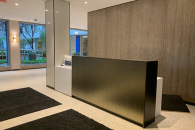 Inspiration for a large modern terrazzo floor, white floor and wall paneling entryway remodel in New York with gray walls and a metal front door