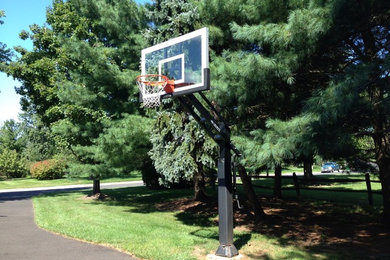 Photo of a large traditional full sun front yard driveway in Philadelphia for summer.