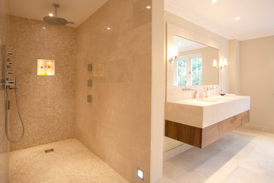 Design ideas for a medium sized contemporary ensuite bathroom in Berkshire with flat-panel cabinets, brown cabinets, a walk-in shower, beige walls, limestone flooring, an integrated sink, limestone worktops, yellow floors, an open shower, yellow worktops, a wall niche, double sinks and a floating vanity unit.