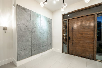 Example of a large minimalist entryway design in Houston with a dark wood front door