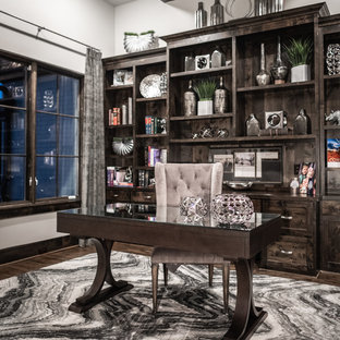 Modern study in Dallas with grey walls, dark hardwood flooring, a freestanding desk and brown floors.