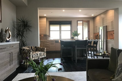 Inspiration for a mid-sized transitional u-shaped dark wood floor and brown floor open concept kitchen remodel in Other with a farmhouse sink, flat-panel cabinets, light wood cabinets, granite countertops, stainless steel appliances and an island