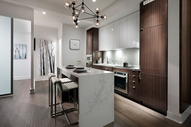 Inspiration for a mid-sized modern galley laminate floor and brown floor eat-in kitchen remodel in Toronto with a single-bowl sink, flat-panel cabinets, dark wood cabinets, quartz countertops, white backsplash, quartz backsplash, paneled appliances, an island and white countertops