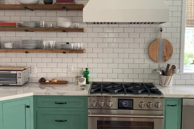 Eat-in kitchen - contemporary l-shaped coffered ceiling eat-in kitchen idea in Philadelphia with stainless steel appliances and a peninsula