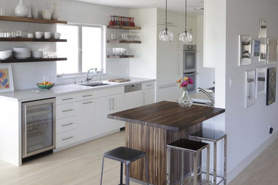 Inspiration for a modern galley kitchen in Birmingham with a single-bowl sink, open cabinets, white cabinets, panelled appliances, quartz benchtops and white splashback.
