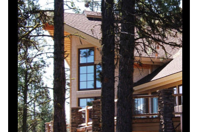 Large mountain style multicolored two-story mixed siding exterior home photo in Albuquerque with a shingle roof