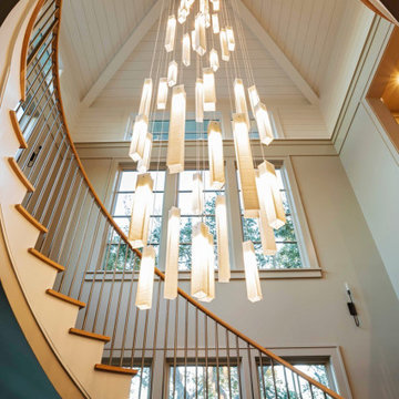 Vertical Glass Chandelier Following a Curved Staircase