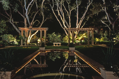 Example of a large tuscan backyard custom-shaped pool design in San Diego