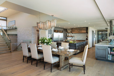 Photo of a mid-sized transitional open plan dining in Orange County with beige walls and light hardwood floors.