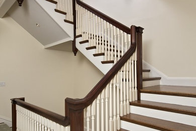 Photo of a mid-sized traditional wood straight staircase in Boston with wood risers and wood railing.
