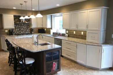 Inspiration for a large transitional l-shaped vinyl floor and beige floor eat-in kitchen remodel in Other with a double-bowl sink, recessed-panel cabinets, white cabinets, granite countertops, brown backsplash, ceramic backsplash, stainless steel appliances and an island