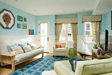 Example of an eclectic living room design in DC Metro with blue walls and a tv stand