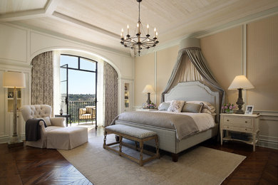 Inspiration for a mediterranean master bedroom in Los Angeles with beige walls, dark hardwood floors and brown floor.