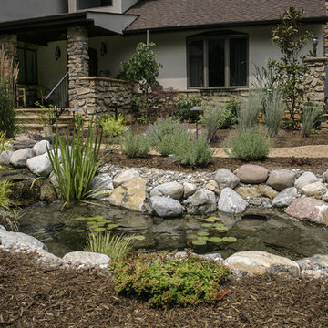 Landscaping with stone hardscape and pond
