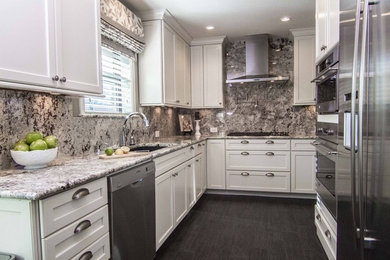 Example of a mid-sized transitional u-shaped porcelain tile and black floor eat-in kitchen design in Dallas with an undermount sink, shaker cabinets, white cabinets, granite countertops, gray backsplash, stone slab backsplash, stainless steel appliances, no island and multicolored countertops