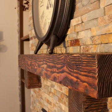 Interior remodel including flooring, stone wall, and lighting.