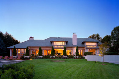 Inspiration for a huge transitional white two-story stucco house exterior remodel in Philadelphia with a hip roof and a shingle roof