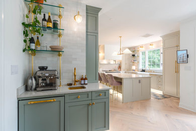 Enclosed kitchen - large french country u-shaped light wood floor and beige floor enclosed kitchen idea in DC Metro with a farmhouse sink, shaker cabinets, white cabinets, quartzite countertops, white backsplash, quartz backsplash, white appliances, an island and beige countertops