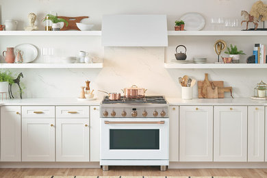 Example of a transitional light wood floor eat-in kitchen design in Portland with recessed-panel cabinets, white cabinets, marble countertops, white backsplash, marble backsplash, white appliances and white countertops