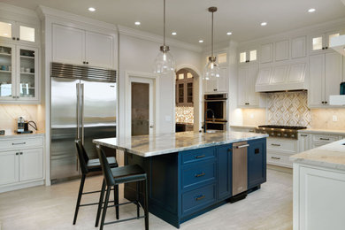 Inspiration for a large transitional l-shaped porcelain tile and beige floor open concept kitchen remodel in San Francisco with an undermount sink, beaded inset cabinets, white cabinets, quartzite countertops, white backsplash, marble backsplash, stainless steel appliances, an island and blue countertops