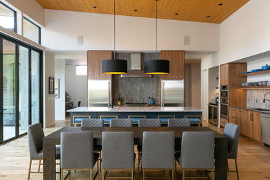Large trendy light wood floor and beige floor eat-in kitchen photo in Vancouver with flat-panel cabinets, medium tone wood cabinets, marble countertops, gray backsplash, ceramic backsplash, stainless steel appliances, an island, gray countertops and a single-bowl sink