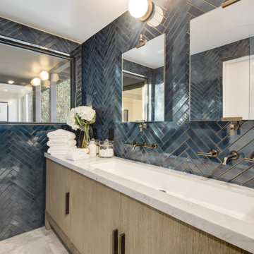 After - Blue Herringbone Tile Behind a Marble Trough Vanity