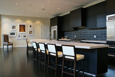 Open concept kitchen - huge contemporary dark wood floor open concept kitchen idea in Chicago with an undermount sink, flat-panel cabinets, dark wood cabinets, concrete countertops, gray backsplash, porcelain backsplash, stainless steel appliances and a peninsula