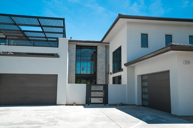 Entryway - large contemporary entryway idea in Sacramento with white walls and a glass front door