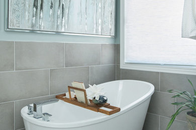 Mid-sized transitional master gray tile and porcelain tile porcelain tile and gray floor bathroom photo in Kansas City with raised-panel cabinets, white cabinets, a two-piece toilet, blue walls, an undermount sink, quartz countertops, a hinged shower door and gray countertops