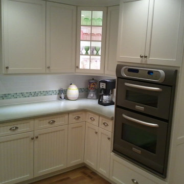 Sea Green Corian and White Cabinetry