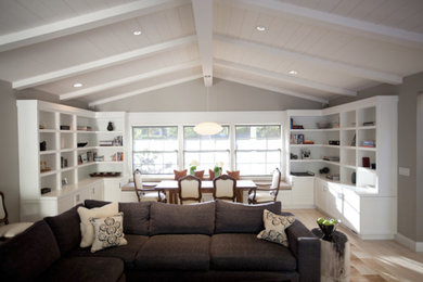 Large transitional light wood floor, brown floor and vaulted ceiling great room photo in Denver with gray walls