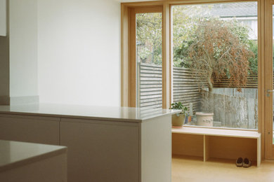 Medium sized contemporary dining room in London with white walls and cork flooring.