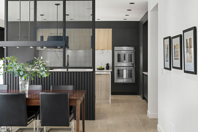 Eat-in kitchen - contemporary l-shaped light wood floor and beige floor eat-in kitchen idea in Calgary with an undermount sink, flat-panel cabinets, light wood cabinets, quartz countertops, white backsplash, quartz backsplash, stainless steel appliances, an island and white countertops