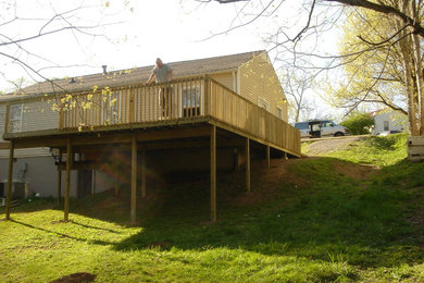 Photo of a mid-sized contemporary backyard deck in Nashville with a water feature and no cover.