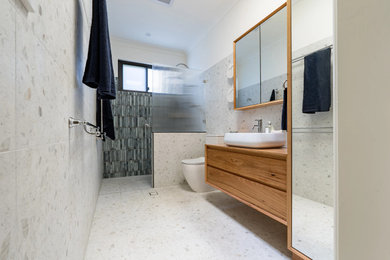 Design ideas for a mid-sized modern 3/4 bathroom in Sydney with flat-panel cabinets, medium wood cabinets, an open shower, a two-piece toilet, multi-coloured tile, porcelain tile, white walls, porcelain floors, a vessel sink, wood benchtops, multi-coloured floor, an open shower, a single vanity and a floating vanity.