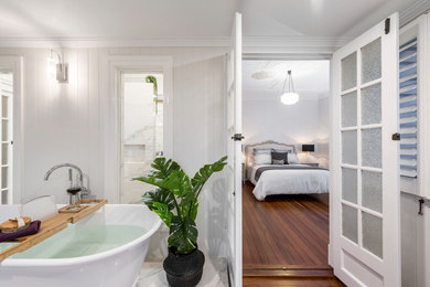 This is an example of a large transitional master bathroom in Brisbane with shaker cabinets, beige cabinets, a freestanding tub, an open shower, a one-piece toilet, white tile, porcelain tile, white walls, ceramic floors, a vessel sink, engineered quartz benchtops, grey floor, an open shower and grey benchtops.