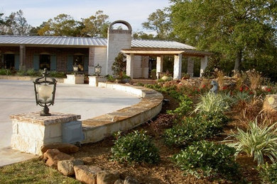 This is an example of a full sun front yard driveway in Houston.