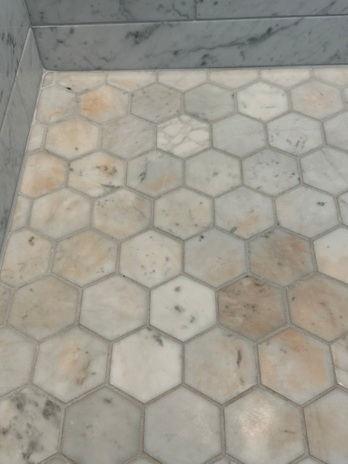 Could spray sunscreen discolor our marble shower floor? Coincidence?