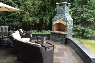 Inspiration for a traditional backyard patio in Providence with a fire feature, concrete pavers and no cover.