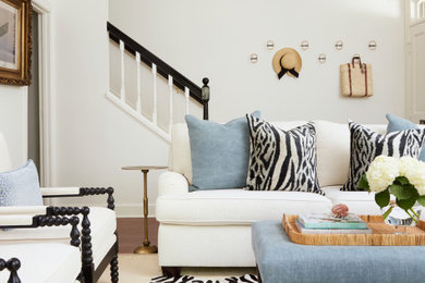 Inspiration for a mid-sized transitional formal and open concept medium tone wood floor living room remodel in Milwaukee with white walls and a wall-mounted tv