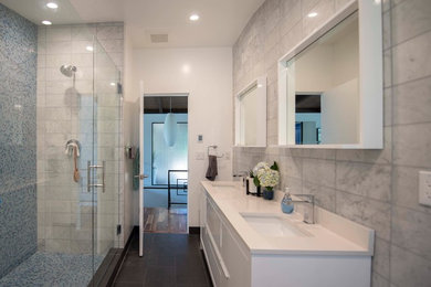 Mid-sized minimalist master white tile and glass sheet porcelain tile and black floor corner shower photo in Other with furniture-like cabinets, white cabinets, a two-piece toilet, white walls, an integrated sink, quartzite countertops, a hinged shower door and white countertops